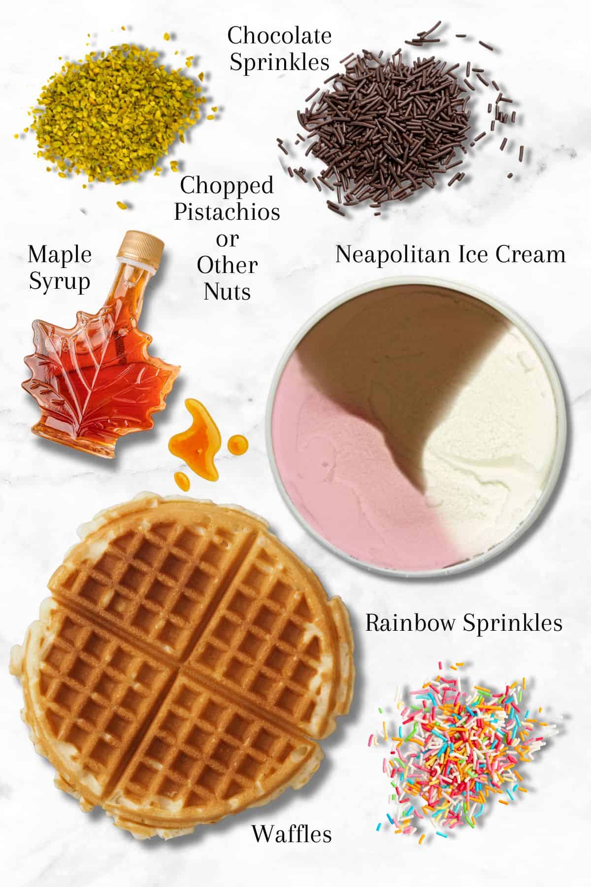 A flat lay on a white surface showing Neapolitan ice cream, a waffle, maple syrup in a small bowl, chocolate sprinkles, chopped pistachios, and rainbow sprinkles. Each item is labeled.