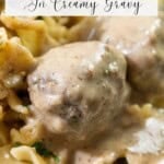 Close-up of Swedish meatballs covered in creamy gravy, served atop egg noodles. Text overlay: "Swedish Meatballs In Creamy Gravy.