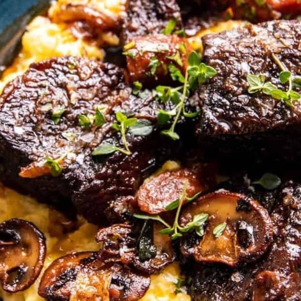 Braised short ribs on creamy polenta, topped with sautéed mushrooms, carrots, and fresh herbs.